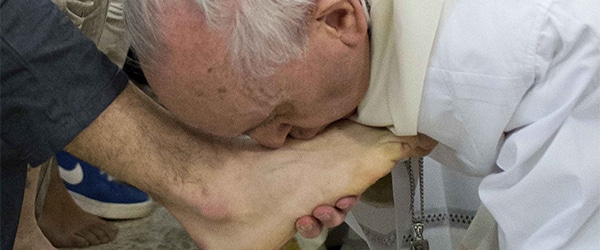 Pope Francis kisses the foot of a prisoner at Casal del Marmo youth prison in Rome